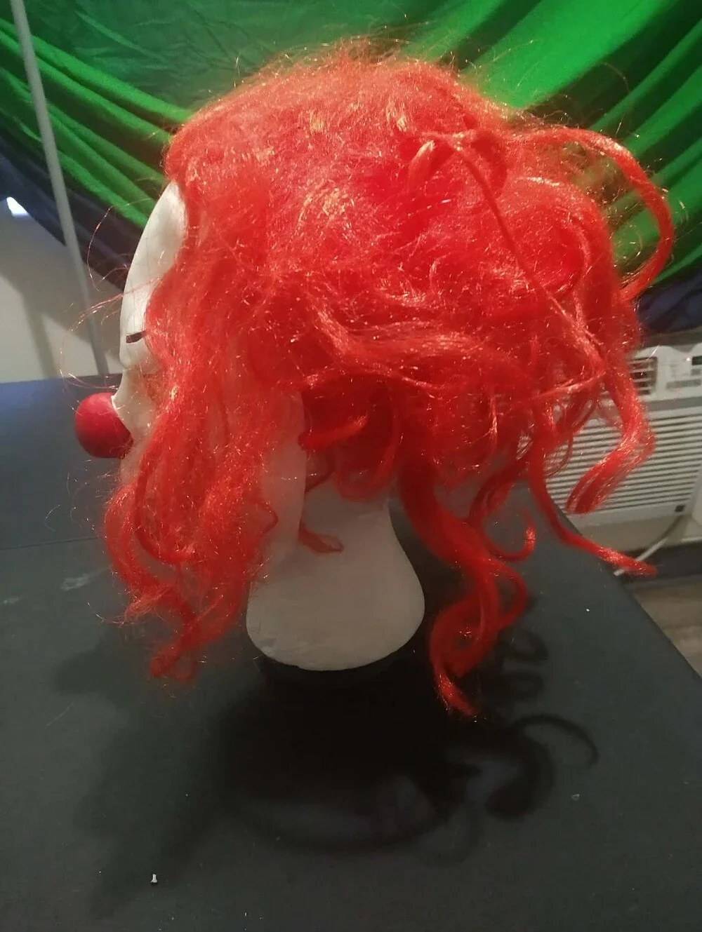 Warner Bros. / Rubie’s scary clown latex mask with bright red synthetic hair